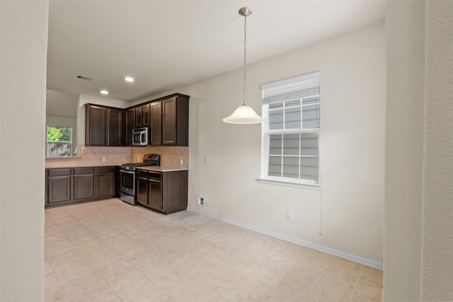 6439 Wilshire Rdg, Houston, TX 77040 - kitchen featuring appliances with stainless steel finishes, dark brown cabinets, backsplash, light countertops, and hanging light fixtures