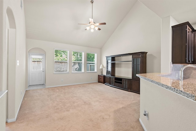 6439 Wilshire Rdg, Houston, TX 77040 - unfurnished living room with a ceiling fan, high vaulted ceiling, light colored carpet, and arched walkways