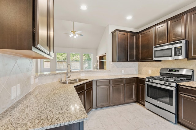 6439 Wilshire Rdg, Houston, TX 77040 - kitchen featuring stainless steel appliances, dark brown cabinetry, ceiling fan, light stone counters, and vaulted ceiling