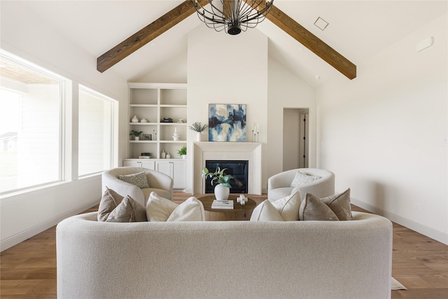 1355 Bluebonnet Ridge Dr, Chappell Hill, TX 77426 - living room featuring beamed ceiling, wood finished floors, a glass covered fireplace, and high vaulted ceiling