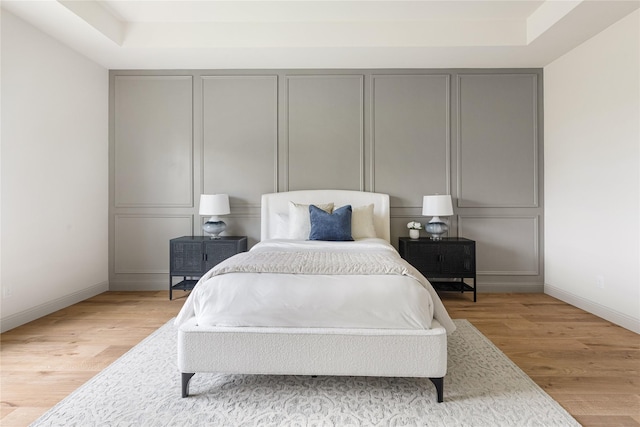 1355 Bluebonnet Ridge Dr, Chappell Hill, TX 77426 - bedroom with light wood-type flooring and a raised ceiling