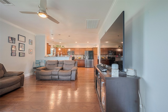 8705 W 1st St, Needville, TX 77461 - living room featuring ceiling fan, light wood-style flooring, and ornamental molding