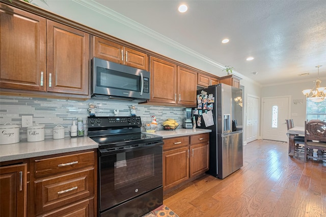 8705 W 1st St, Needville, TX 77461 - kitchen with appliances with stainless steel finishes, a chandelier, light countertops, brown cabinets, and crown molding