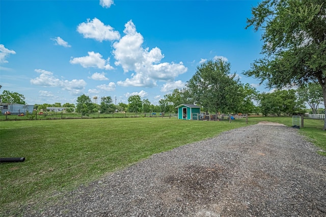 8705 W 1st St, Needville, TX 77461 - view of yard with a storage unit and driveway
