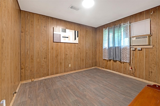 4007 Wedgewood St, Houston, TX 77093 - spare room featuring wood finished floors, wooden walls, and cooling unit