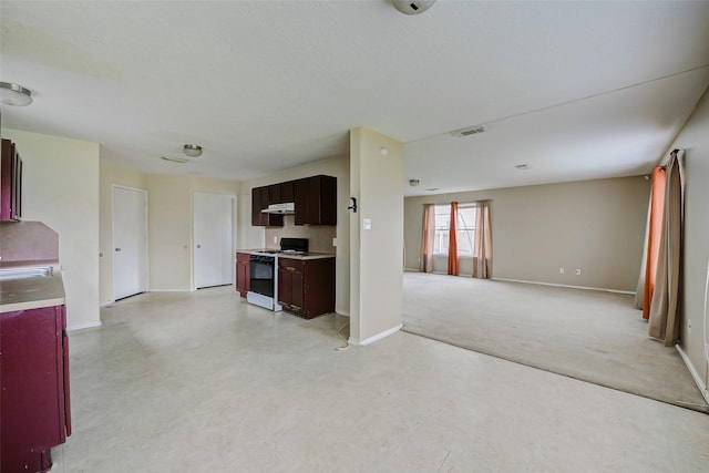 11303 Canyon Shore Dr, Humble, TX 77396 - kitchen with white gas range oven, open floor plan, under cabinet range hood, and light flooring