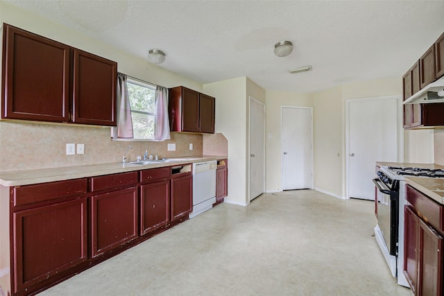 11303 Canyon Shore Dr, Humble, TX 77396 - kitchen with range with gas stovetop, reddish brown cabinets, white dishwasher, decorative backsplash, and light countertops