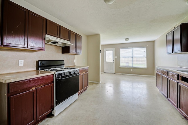 11303 Canyon Shore Dr, Humble, TX 77396 - kitchen with range, under cabinet range hood, light countertops, and a textured ceiling