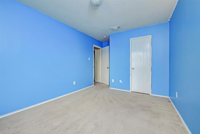 11303 Canyon Shore Dr, Humble, TX 77396 - unfurnished bedroom with carpet floors and a textured ceiling