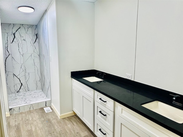 17909 Pine St Unit A, Crosby, TX 77532 - bathroom featuring a marble finish shower, wood finished floors, and double vanity