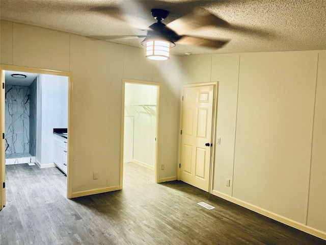17909 Pine St Unit A, Crosby, TX 77532 - spare room featuring ceiling fan, wood finished floors, and a textured ceiling