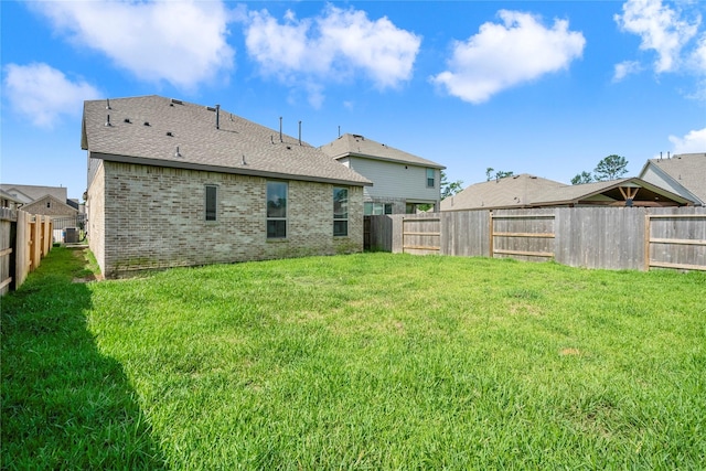 5081 Andorra Bend Ln, Porter, TX 77365 - back of house featuring brick siding, a fenced backyard, and a shingled roof