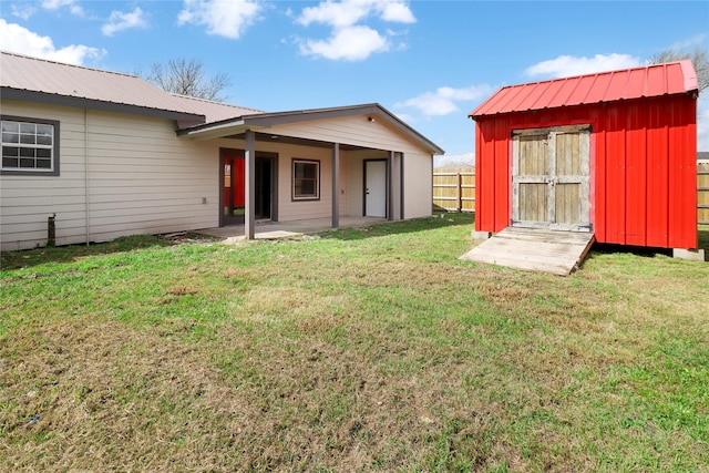 3406 W Cedar Bayou Lynchburg Rd, Baytown, TX 77521 - rear view of house featuring a storage shed, a metal roof, a patio area, and board and batten siding