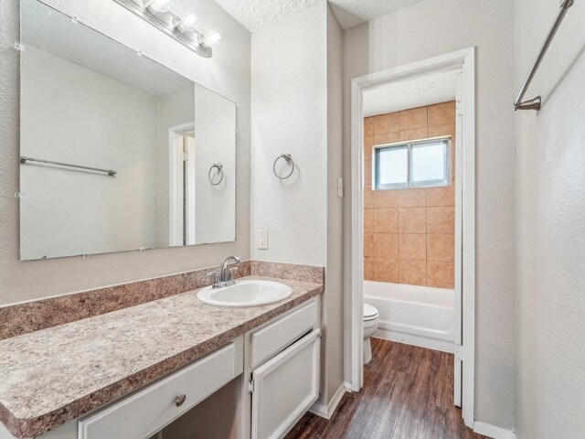 4901 Ripple Creek Dr, Baytown, TX 77521 - full bathroom featuring vanity, wood finished floors, and shower / bath combination