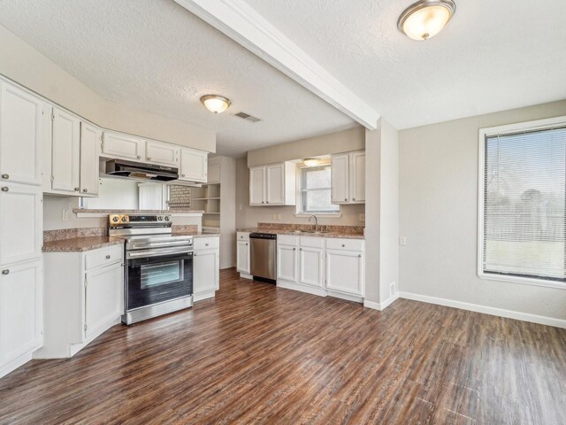4901 Ripple Creek Dr, Baytown, TX 77521 - kitchen featuring stainless steel appliances, under cabinet range hood, dark wood finished floors, white cabinetry, and a textured ceiling