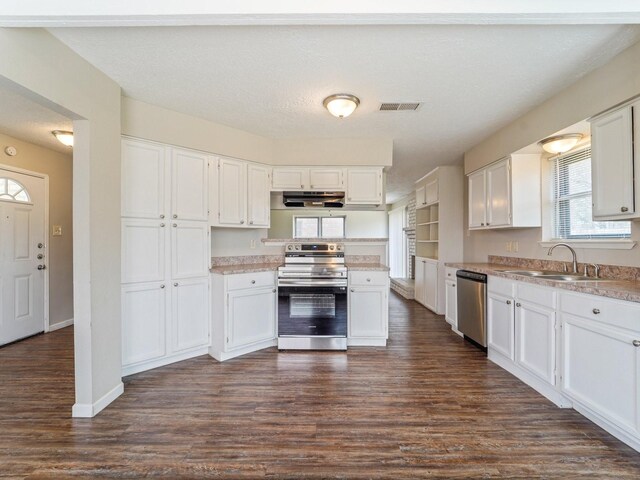 4901 Ripple Creek Dr, Baytown, TX 77521 - kitchen with stainless steel appliances, under cabinet range hood, white cabinets, and dark wood-style floors