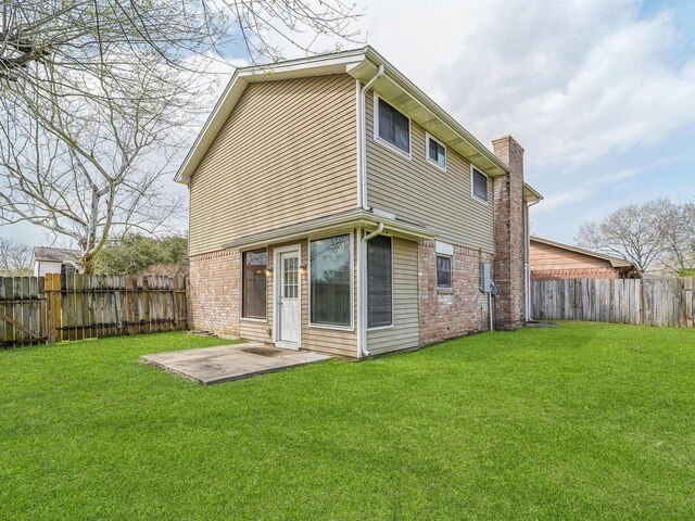 4901 Ripple Creek Dr, Baytown, TX 77521 - rear view of property featuring a chimney, a patio, a fenced backyard, and brick siding