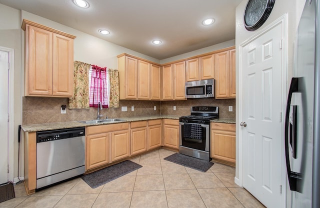 21522 Amesbury Meadow Ln, Spring, TX 77379 - kitchen featuring stainless steel appliances, light brown cabinetry, backsplash, light stone countertops, and recessed lighting