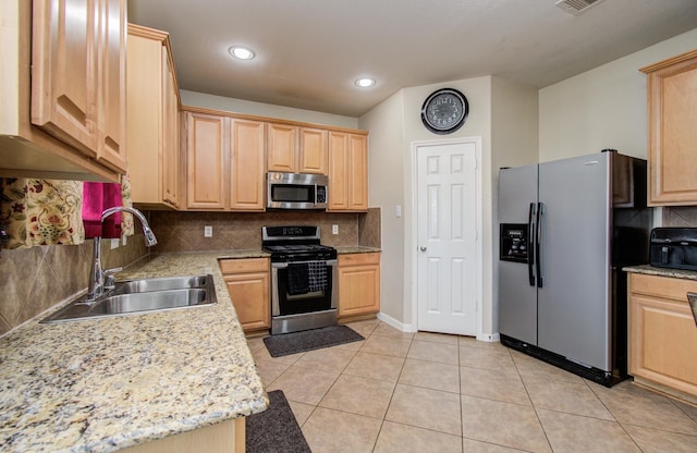 21522 Amesbury Meadow Ln, Spring, TX 77379 - kitchen with stainless steel appliances, light brown cabinetry, backsplash, light tile patterned floors, and recessed lighting