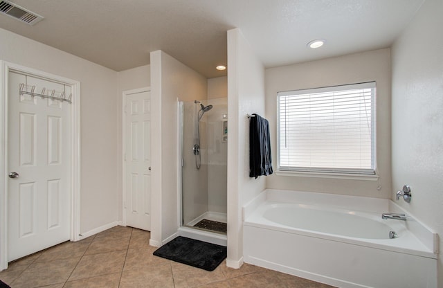 21522 Amesbury Meadow Ln, Spring, TX 77379 - full bathroom with tile patterned flooring, a garden tub, a stall shower, and recessed lighting