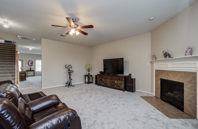 21522 Amesbury Meadow Ln, Spring, TX 77379 - carpeted living area with a fireplace, ceiling fan, and stairway