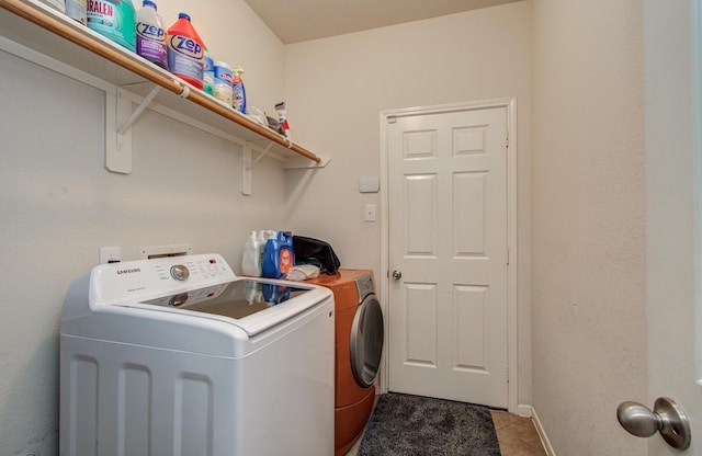 21522 Amesbury Meadow Ln, Spring, TX 77379 - laundry area featuring washer and dryer and tile patterned flooring