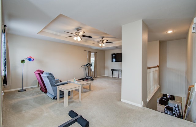 21522 Amesbury Meadow Ln, Spring, TX 77379 - exercise room featuring light colored carpet, a tray ceiling, and a ceiling fan