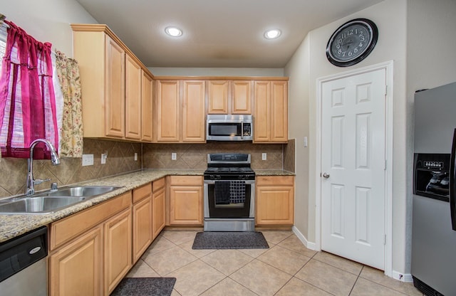 21522 Amesbury Meadow Ln, Spring, TX 77379 - kitchen with appliances with stainless steel finishes, light brown cabinets, decorative backsplash, light tile patterned floors, and recessed lighting