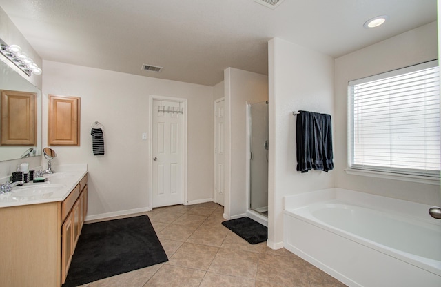 21522 Amesbury Meadow Ln, Spring, TX 77379 - bathroom with double vanity, a bath, tile patterned flooring, and a stall shower