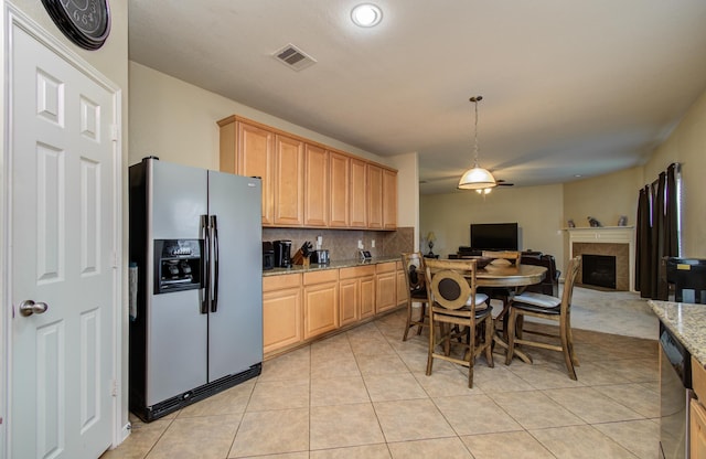 21522 Amesbury Meadow Ln, Spring, TX 77379 - kitchen with stainless steel appliances, backsplash, open floor plan, light tile patterned floors, and light stone counters