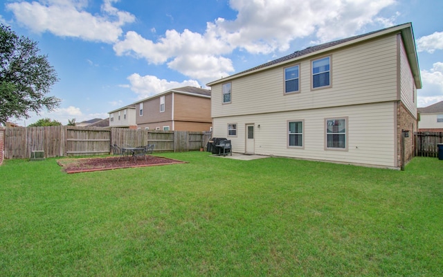 21522 Amesbury Meadow Ln, Spring, TX 77379 - rear view of property featuring a fenced backyard, a patio area, and brick siding