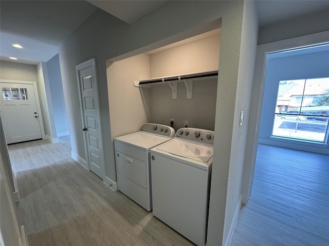 9803 Club Creek Dr Unit 134, Houston, TX 77036 - washroom featuring washing machine and clothes dryer, light wood-style flooring, and recessed lighting