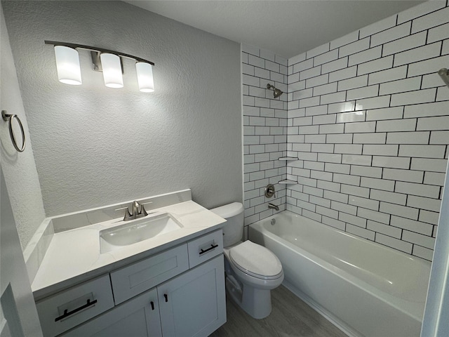 9803 Club Creek Dr Unit 134, Houston, TX 77036 - bathroom featuring vanity, wood finished floors, shower / bath combination, and a textured wall