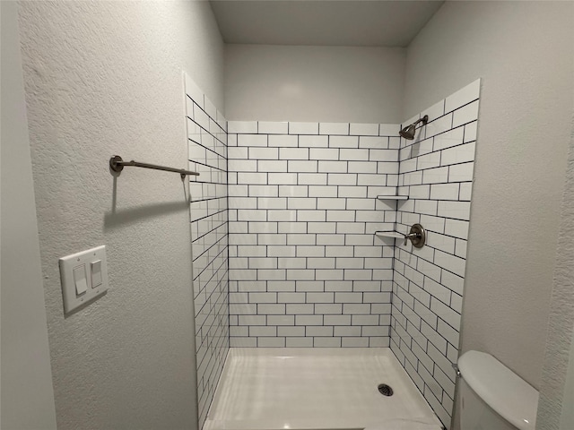 9803 Club Creek Dr Unit 134, Houston, TX 77036 - bathroom featuring a stall shower and a textured wall