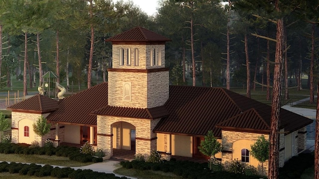 18923 Toscana Ln, New Caney, TX 77357 - view of front of home with stone siding, a standing seam roof, and a metal roof