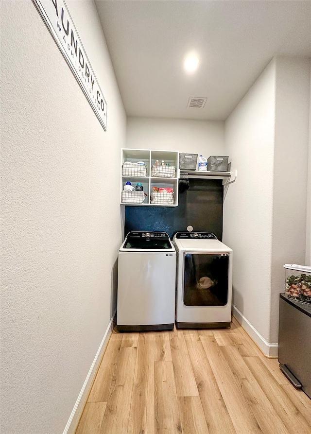18923 Toscana Ln, New Caney, TX 77357 - washroom with wood finished floors and washing machine and dryer