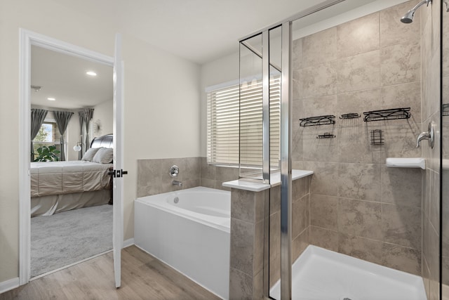 10433 Russell Pines Dr, Rosharon, TX 77583 - ensuite bathroom featuring a garden tub, wood finished floors, and a stall shower