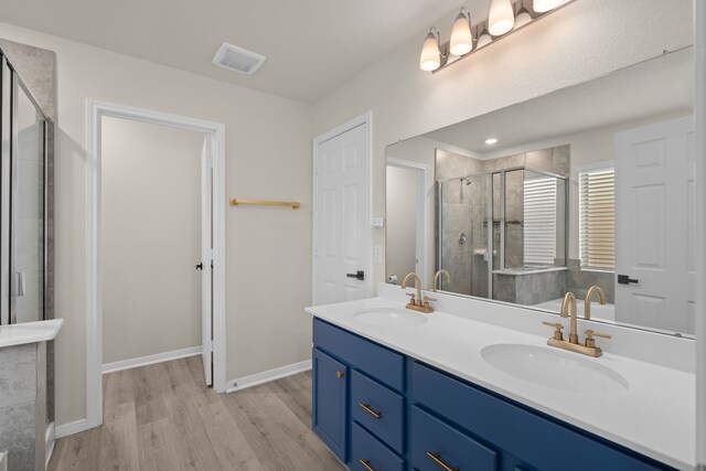 10433 Russell Pines Dr, Rosharon, TX 77583 - full bath featuring double vanity, wood finished floors, and a stall shower