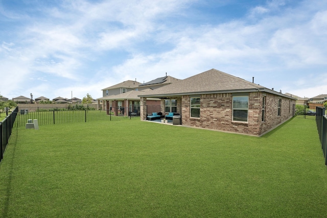 10433 Russell Pines Dr, Rosharon, TX 77583 - back of house with a fenced backyard, brick siding, a shingled roof, outdoor lounge area, and a patio