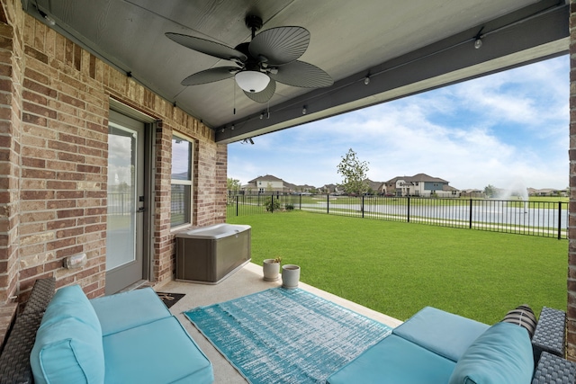 10433 Russell Pines Dr, Rosharon, TX 77583 - fenced backyard with ceiling fan, a water view, an outdoor hangout area, a patio area, and a residential view