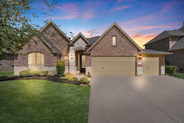 5622 Chipstone Trail Ln, Katy, TX 77493 - french country inspired facade with a garage, concrete driveway, a yard, brick siding, and stone siding