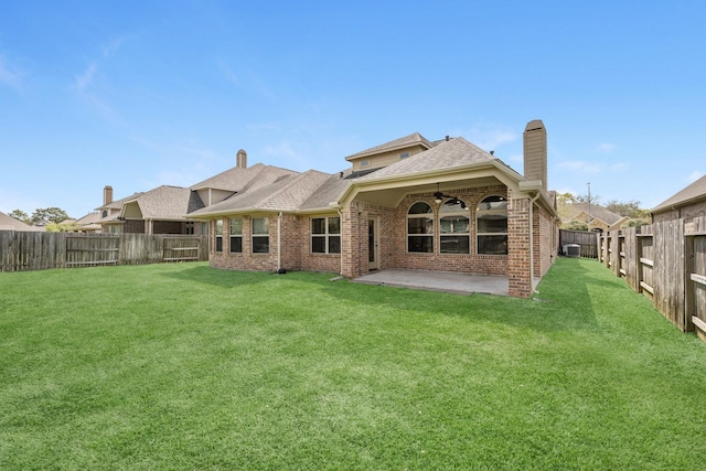 5622 Chipstone Trail Ln, Katy, TX 77493 - rear view of house with ceiling fan, a fenced backyard, a patio, a chimney, and brick siding