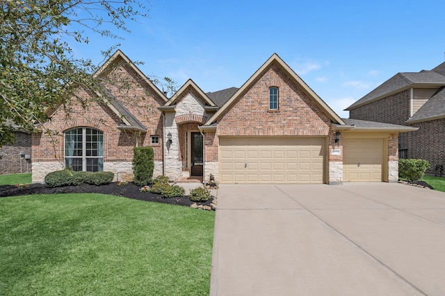 5622 Chipstone Trail Ln, Katy, TX 77493 - french provincial home with a garage, a front lawn, concrete driveway, brick siding, and stone siding