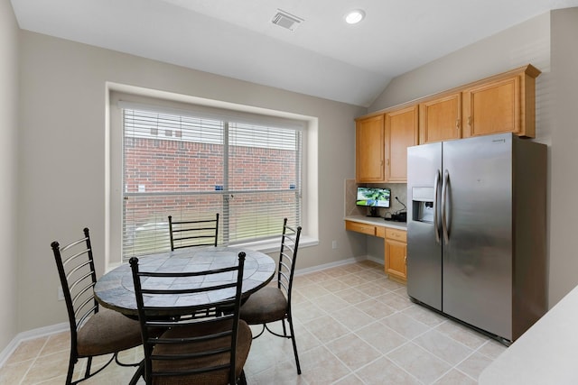 15215 Millers Run Ln, Sugar Land, TX 77498 - kitchen featuring stainless steel fridge, built in study area, lofted ceiling, light tile patterned floors, and light countertops