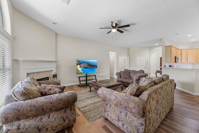 15215 Millers Run Ln, Sugar Land, TX 77498 - living area featuring ceiling fan, a tile fireplace, wood finished floors, arched walkways, and recessed lighting