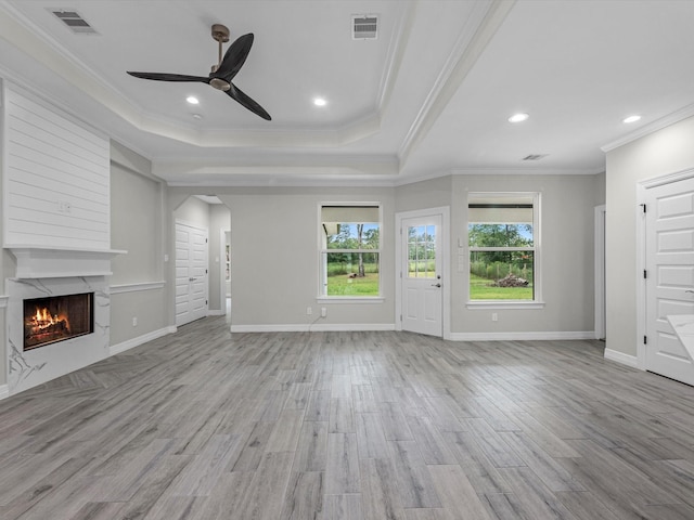 14606 Half Circle St, Splendora, TX 77372 - unfurnished living room with ceiling fan, a premium fireplace, light wood-style flooring, arched walkways, and ornamental molding