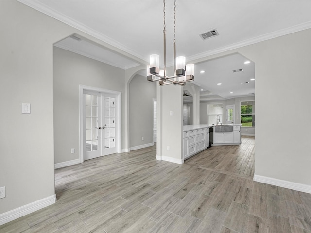 14606 Half Circle St, Splendora, TX 77372 - unfurnished living room featuring arched walkways, a chandelier, light wood finished floors, french doors, and ornamental molding