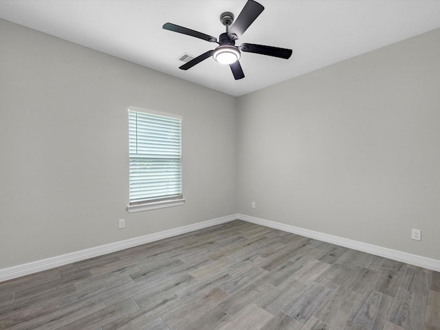 14606 Half Circle St, Splendora, TX 77372 - empty room with wood finished floors and a ceiling fan