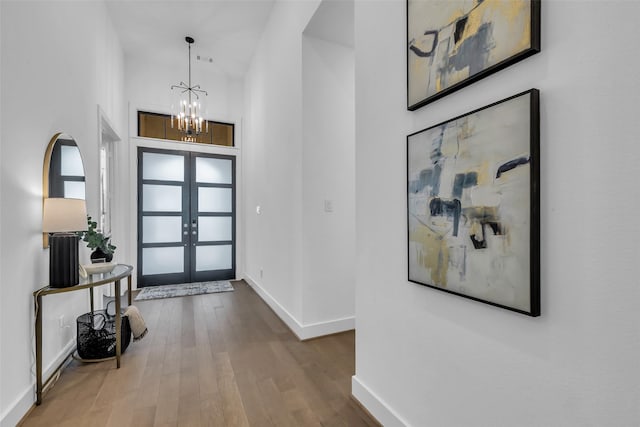 6826 Mirabeau Ln, Katy, TX 77493 - foyer entrance with french doors, wood finished floors, a chandelier, and a towering ceiling