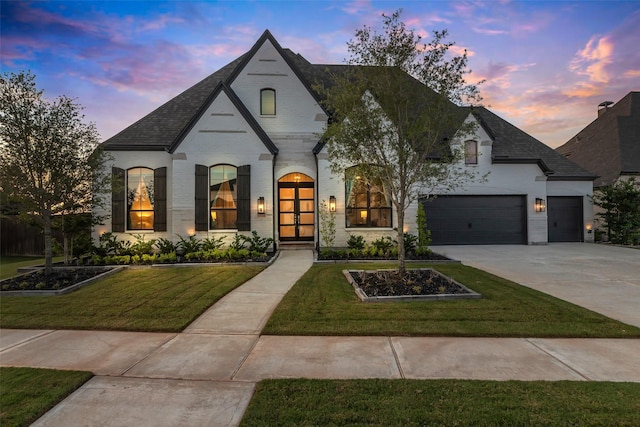 6826 Mirabeau Ln, Katy, TX 77493 - french country style house featuring a lawn, concrete driveway, roof with shingles, and brick siding